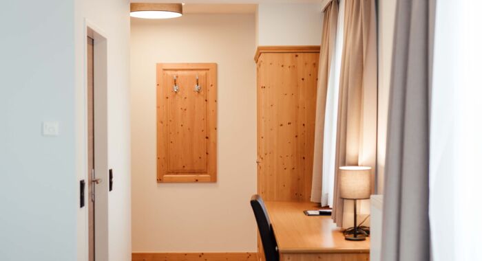 Schreibtisch und großer Holzschrank im Doppelzimmer des Landgasthofs Kirchbichl