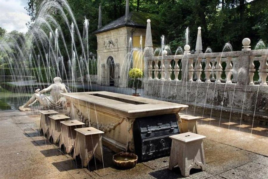 The Hellbrunn fountains include a table and chairs with concealed water jets